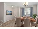 Elegant dining room with hardwood floors, a chandelier, and bright natural light at 709 Wickham Ridge Rd, Apex, NC 27539