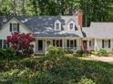 Attractive two-story home boasting a manicured front lawn, dormer windows, and a welcoming porch at 7401 Walnut Grove Ln, Zebulon, NC 27597