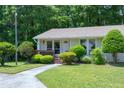 View of the house, highlighting the well-kept lawn, landscaping, and charming architectural details at 103 Westview Dr # Apt K, Carrboro, NC 27510