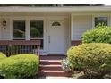 Inviting front porch and door, enhanced by lush greenery, and a light and bright ambiance at 103 Westview Dr # Apt K, Carrboro, NC 27510