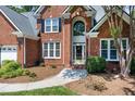 Inviting entryway with manicured landscaping, walkway, and classic brick facade at 105 Bardsey Ct, Cary, NC 27513