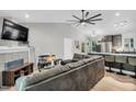 Spacious living room features vaulted ceilings, a ceiling fan, and flows into the eat-in kitchen at 106 Blackfoot Dr, Louisburg, NC 27549