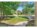 Traditional two-story home with green lawn and mature trees, as seen from the porch at 11 Bridgeport Dr, Durham, NC 27713