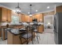 Stylish kitchen with stainless steel appliances, granite countertops, and tile flooring at 11 Smoketree Ct, Durham, NC 27712