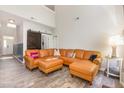 A spacious living room with a large leather sectional, high ceilings, and sliding barn door at 1101 Washhouse Ln, Wake Forest, NC 27587
