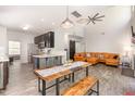 Open concept living space featuring modern decor, a cozy living room, and dining table with bench seating at 1101 Washhouse Ln, Wake Forest, NC 27587