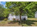 Charming home with a well-manicured lawn and mature shade tree in the front yard at 1112 Mark St, Raleigh, NC 27601