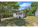 Charming home with a well-manicured lawn and mature shade trees in the front yard at 1112 Mark St, Raleigh, NC 27601