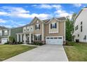 Charming two-story home with a well-manicured lawn, covered porch and attached two car garage at 112 Serenata Dr, Holly Springs, NC 27540