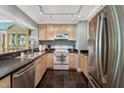 Functional kitchen featuring stainless steel appliances and tile flooring at 11470 Club Dr, Chapel Hill, NC 27517