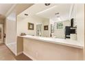 Open-concept kitchen space with a serving counter and direct access to living and dining areas at 11475 Club Dr, Chapel Hill, NC 27517
