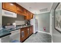 Functional kitchen with wood cabinets, stainless steel sink, and essential appliances at 11483 Club Dr, Chapel Hill, NC 27517