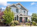 Charming two-story home with a covered front porch, stone accents, and a well-manicured lawn at 12 Beacon Ridge Blvd, Chapel Hill, NC 27516