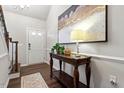 Bright foyer featuring dark wood floors, decorative table, and stylish artwork at 12404 Huntley Chase Dr, Durham, NC 27703
