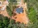 An aerial view of a gray home surrounded by trees and landscaping, showcasing the neighborhood's serene setting at 125 Purslane Dr, Franklinton, NC 27525