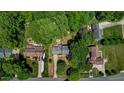 An aerial view of a home on a large lot surrounded by mature trees and landscaping at 1274 Candlewood Dr, Elon, NC 27244