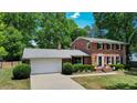 Charming two-story brick home features manicured landscaping and an attached two-car garage at 1274 Candlewood Dr, Elon, NC 27244