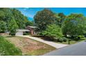 Brick two-story home with mature trees and a long driveway at 1274 Candlewood Dr, Elon, NC 27244