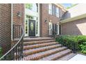 Inviting brick home entrance with an elegant front door and meticulously maintained landscaping at 1312 Glenden Falls Way, Raleigh, NC 27614