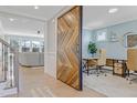 Bright home office with a large sliding barn door and views of a formal living room at 155 Annabelle Branch Ln, Apex, NC 27523