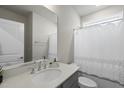Clean bathroom features a large mirror, updated vanity, white shower curtain, and natural light at 1641 Glazebrook Dr, Wake Forest, NC 27587