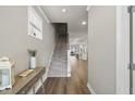 Inviting foyer with hardwood floors, staircase, and an open view into the living spaces at 1641 Glazebrook Dr, Wake Forest, NC 27587