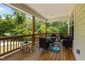 Inviting covered porch furnished with outdoor seating and play area surrounded by lush greenery at 2003 Wa Wa Ave, Durham, NC 27707