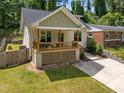 Charming bungalow with a covered front porch, wooden deck, and well-maintained lawn at 2003 Wa Wa Ave, Durham, NC 27707
