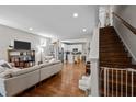 Spacious living room with hardwood floors, a staircase, and an open view to the kitchen at 2003 Wa Wa Ave, Durham, NC 27707