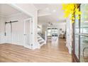 Bright foyer with wood floors, and views of the stairs and open living area, creating a seamless transition at 2014 Anna Lilley Dr, Fuquay Varina, NC 27526