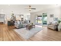 Bright open-plan living room boasts lots of natural light, wood floors and a stylish neutral color scheme at 2014 Anna Lilley Dr, Fuquay Varina, NC 27526