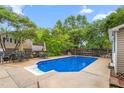 Beautiful backyard featuring an in-ground pool, patio furniture, and mature trees for shade at 204 Random Ln, Burlington, NC 27215