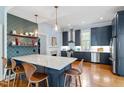 Modern kitchen with a large island, stainless steel appliances, and open shelving at 216 N Bloodworth St, Raleigh, NC 27601