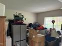 Cluttered bedroom with neutral walls and natural light streaming through the window at 216 Ruby Walk Dr, Morrisville, NC 27560