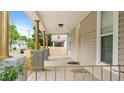 Spacious front porch featuring decorative columns and railing, perfect for relaxing outdoors at 223 Hall Ave, Burlington, NC 27217
