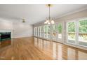 Bright living room with wood floors, fireplace, many windows and a glass door with access to deck at 2303 Upper Oaks Way, Raleigh, NC 27615