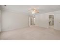 Spacious main bedroom featuring a neutral carpet, a ceiling fan and plenty of closet space at 2303 Upper Oaks Way, Raleigh, NC 27615
