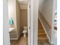 Half bath showing modern sink, toilet and stairs with wood banister at 238 Oak Meadow Ln, Angier, NC 27501