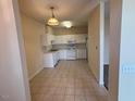 View of the kitchen featuring white cabinets, appliances, and ample counter space at 2521 Friedland Pl # 301, Raleigh, NC 27617