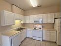 Functional kitchen features white cabinets, appliances, and ample counter space at 2521 Friedland Pl # 301, Raleigh, NC 27617