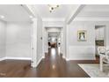 Inviting foyer with hardwood floors that opens to the living room and dining area at 2527 Sidewinder Ct, Apex, NC 27523