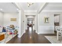 Inviting foyer with gleaming hardwood floors and elegant trim, showcasing a view through to the Gathering room at 2527 Sidewinder Ct, Apex, NC 27523