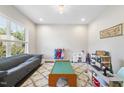 Spacious living room with a large window, plush seating, and ample space for activities at 2527 Sidewinder Ct, Apex, NC 27523