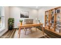 Bright home office with custom built-in shelves, a work space, and an area rug at 2527 Sidewinder Ct, Apex, NC 27523