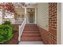 Inviting entryway with brick stairs leading to the front door at 2728 Cameron Pond Dr, Cary, NC 27519