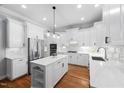 Stunning white kitchen with an island, stainless steel appliances, and elegant countertops at 2728 Cameron Pond Dr, Cary, NC 27519