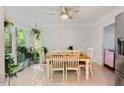 Bright dining area features a ceiling fan and large windows overlooking the lush yard at 307 Durington Pl, Cary, NC 27518