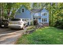 Beautiful two-story home with light blue siding, front yard and an attached two-car garage at 307 Durington Pl, Cary, NC 27518