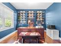 Beautiful office with blue walls, built-in shelves, hardwood floors, and a large window for natural light at 311 Ocean Dr, Clayton, NC 27520