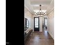 Elegant entryway with hardwood floors, decorative wallpaper, stylish lighting, and a front door at 3521 Olive Glen Dr, Apex, NC 27502